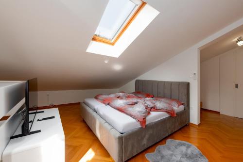 a bedroom with a bed and a skylight at SeaView Lovran in Lovran