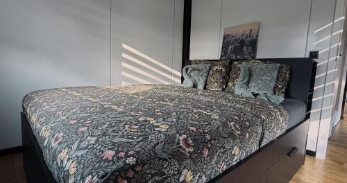 a bedroom with a bed with a comforter and pillows at Maya tempel - De IJsvogel in Voorthuizen