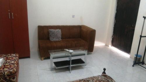 a living room with a couch and a coffee table at House Sol - 8 in Al Ain
