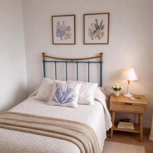 a bedroom with a bed with two pictures on the wall at Apartamento Rural Borgia in Borja