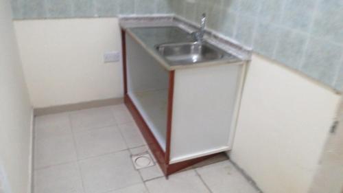 a small kitchen with a sink in a room at House Sol - 8 in Al Ain