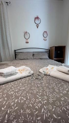 a bedroom with two beds with towels on the floor at sunwave Tolo in Tolo