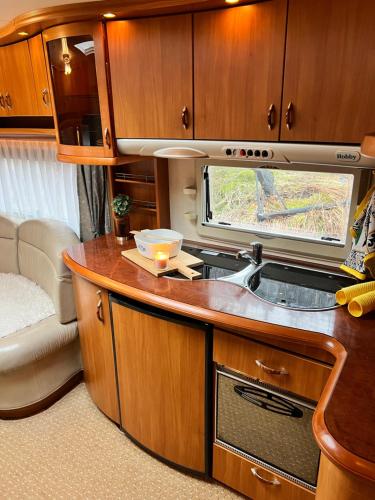 a kitchen in an rv with a sink at Nordic Dream Camper 1 in Syfteland