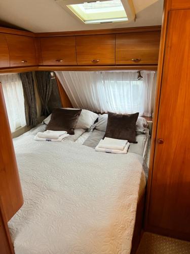 a bed in the middle of a small room at Nordic Dream Camper 1 in Syfteland