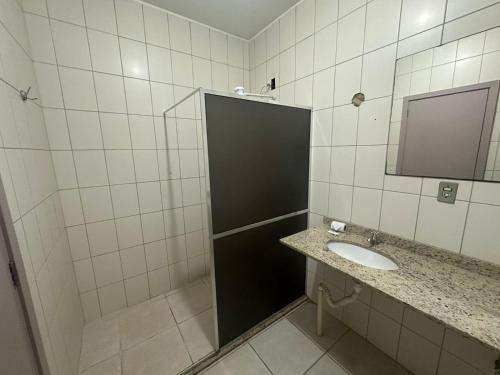 a bathroom with a sink and a mirror at Hotel Guaporé - Campo Bom RS in Campo Bom