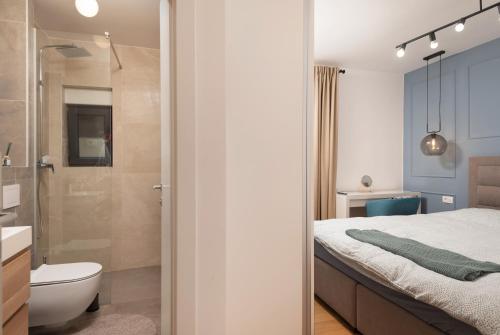 a bedroom with a shower and a bed and a toilet at Villa Voyage in Zadar