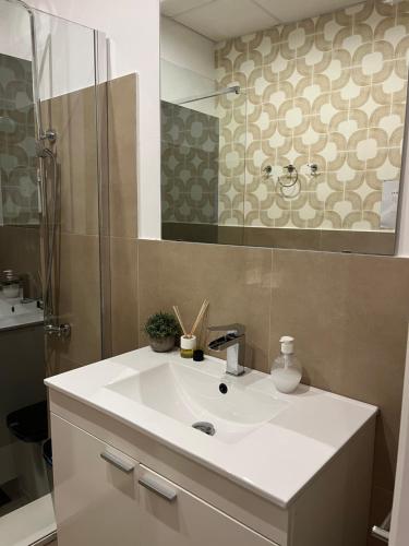 a bathroom with a white sink and a shower at Rota Beach Loft in Rota