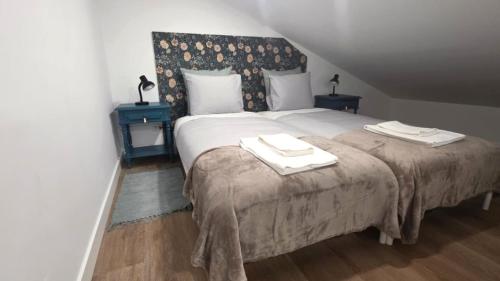a bedroom with a large bed with two towels on it at Casinhas da Ajuda nº15 in Lisbon