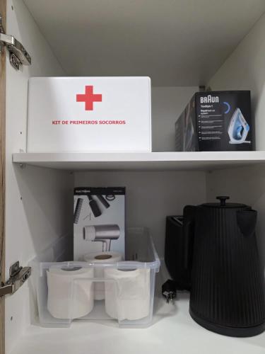 a shelf with a box and two toilets on it at Casinhas da Ajuda nº15 in Lisbon