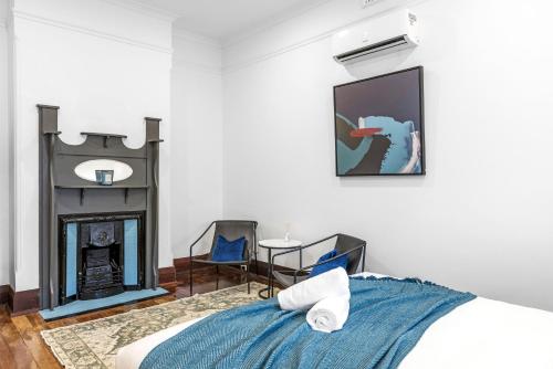 a bedroom with a bed and a fireplace at North Perth 3BR Home Steps To Hyde Park & Dining in Perth