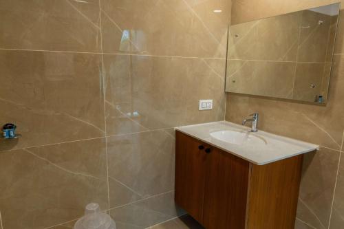 a bathroom with a sink and a shower at Joven's central hotel in Bangalore