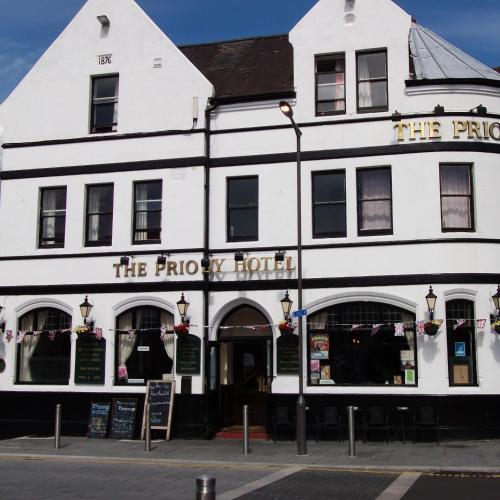 a white building on the corner of a street at Dover Priory Hotel in Dover