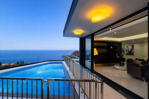 a view of a swimming pool from a house at Luxury Ocean View Villa I Swimming pool I Vincents Place in Estreito da Calheta