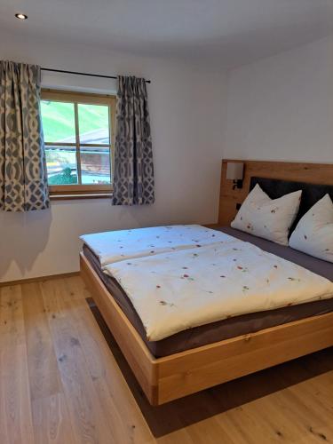 a bedroom with a large bed in a room at Ferienwohnung Altrach in Aurach bei Kitzbuhel
