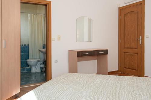 a bedroom with a bed and a bathroom with a toilet at Montemar Villas in Sunny Beach
