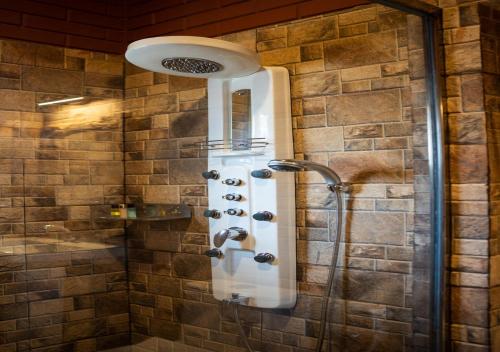 a shower in a bathroom with a shower head at Resotree in Talai