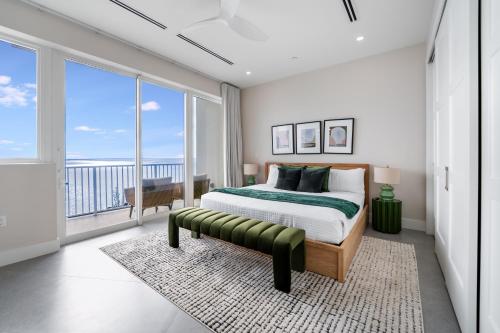 a bedroom with a bed and a view of the ocean at Point West Premier Rentals in West Bay