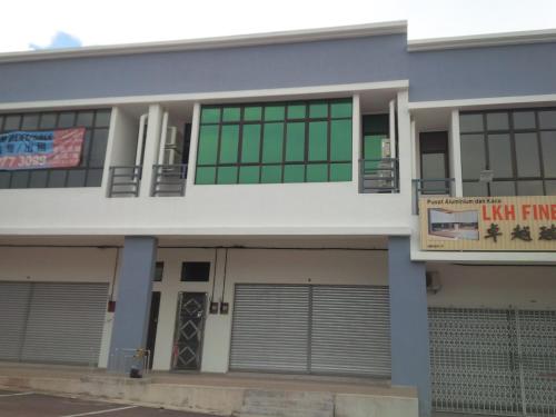 a building with a sign in front of it at Eiman Homestay, Kluang in Kluang