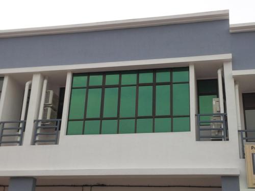 a house with green windows on it at Eiman Homestay, Kluang in Kluang