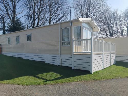a mobile home with a porch on the side of it at Washbrook Way 2 in Fenny Bentley