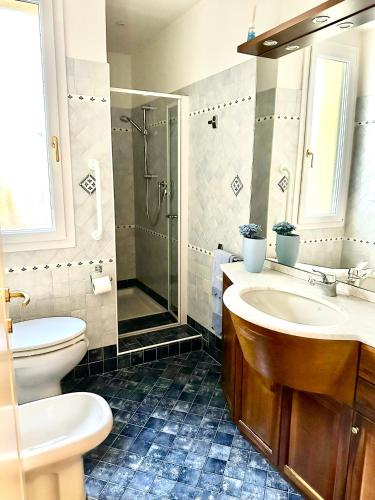 a bathroom with a sink and a toilet and a shower at Le Due Sorelle in Savio di Ravenna