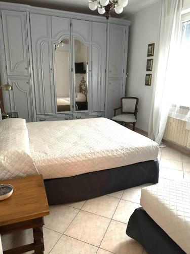a bedroom with a bed and a table and a mirror at Le Due Sorelle in Savio di Ravenna