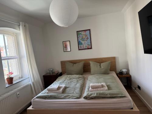 a bed in a bedroom with two pillows on it at Zum alten Pasewalker Kaufmann in Pasewalk