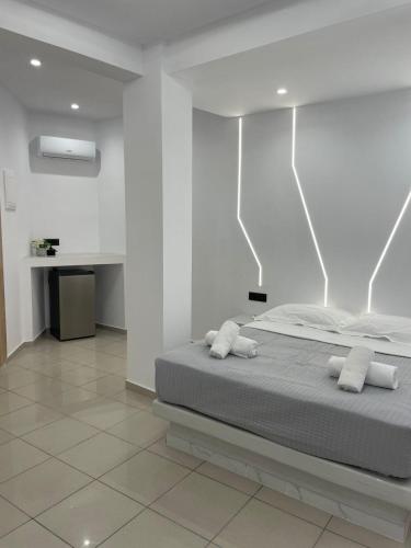 a bedroom with a bed with two white pillows at Fira centerline Prestige suites in Fira