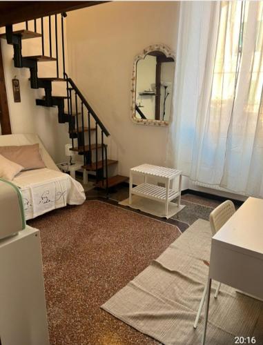 a room with a bed and a staircase with a mirror at Casa sulla spiaggia in Genoa