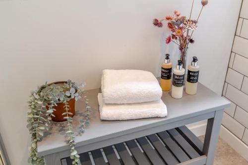 a table with towels and flowers on it at 3 Bed in Ullapool oc-s33063 in Ullapool