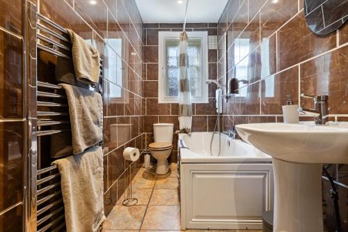a bathroom with a sink and a toilet at Mar Apartment in Stirling