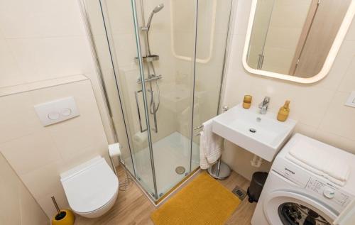 a bathroom with a shower and a toilet and a sink at Cres Sea & Sunset View in Cres