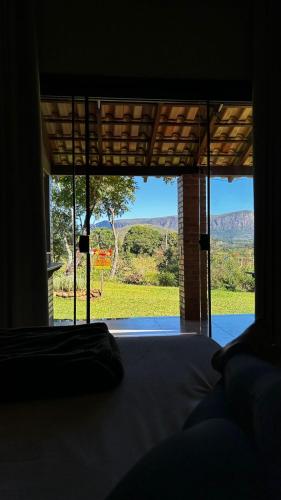 a room with a bed and a window with a view at Pousada Velho Chico in Vargem Bonita