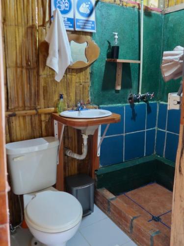 a bathroom with a toilet and a sink at Sinchi Warmi Amazon Lodge in Puerto Misahuallí