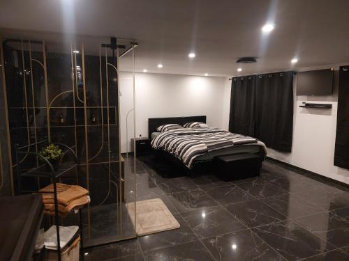 a bedroom with a bed and a glass shower at Suite Privée Deluxe O'Palawan Gold PROCHE TOURCOING CENTRE in Tourcoing