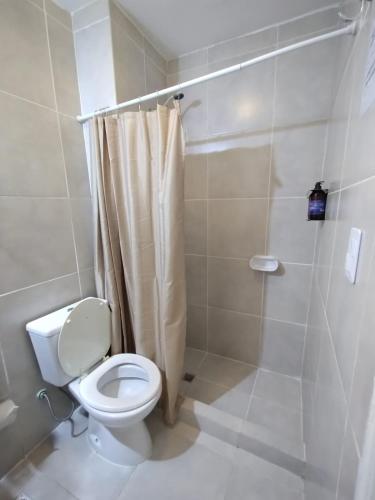 a bathroom with a toilet and a shower at Hosteria Alma de Patagonia in El Chalten