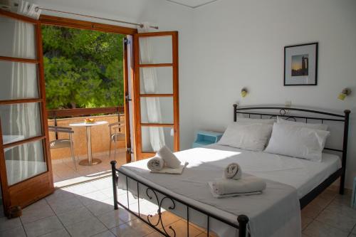 a bedroom with a bed with towels on it at Agistri Island Dream in Skala