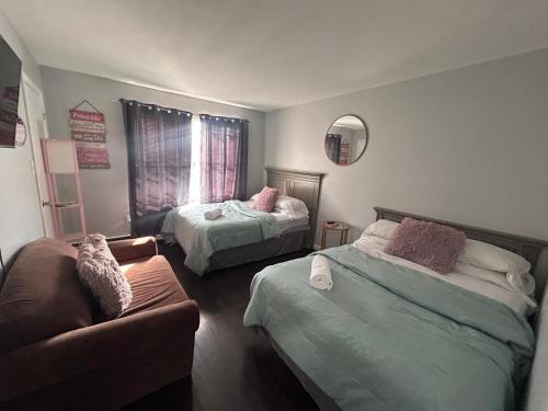 a living room with two beds and a couch at Kickback and relax in Elizabeth