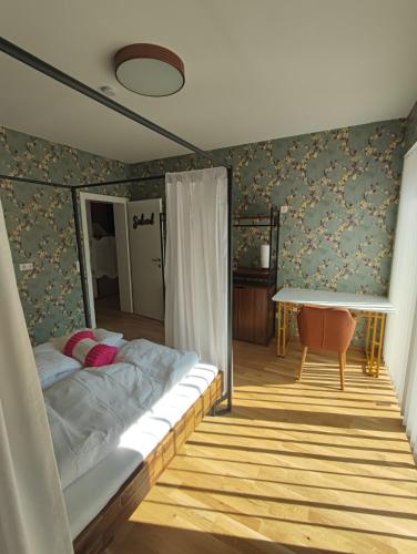 a bedroom with a bed and a table in it at "Villa Barta am See" - Salzkammergut erleben in Traunkirchen
