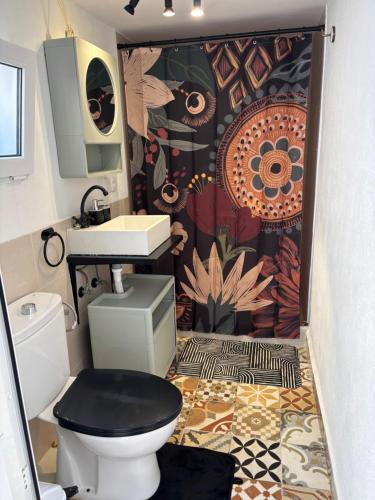 a bathroom with a toilet and a sink at La casita de Denis in Periana