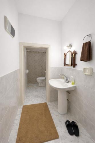 a white bathroom with a sink and a toilet at بيت جرش - Jerash House in Jerash