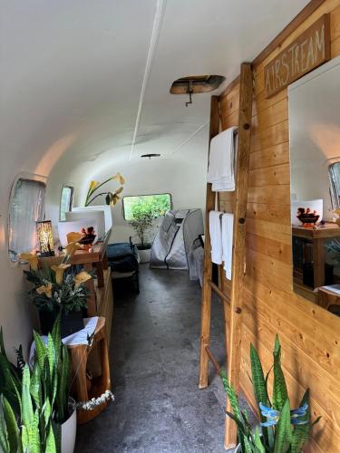 a living room in a travel trailer with plants at Stay and Spa in Sooke