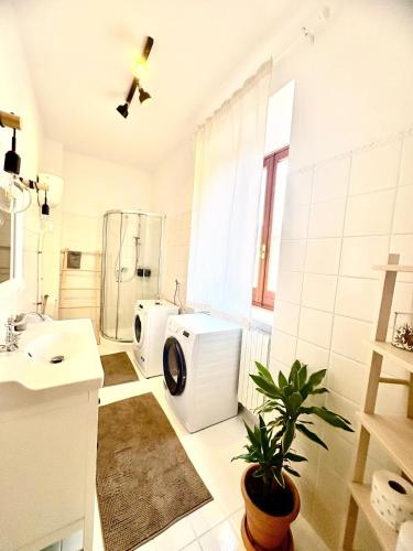 a bathroom with a sink and a washing machine at A casa di Maria in Sulmona