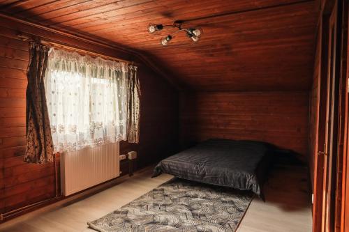 a small room with a bed and a window at Zen Home in Mihai Viteazu