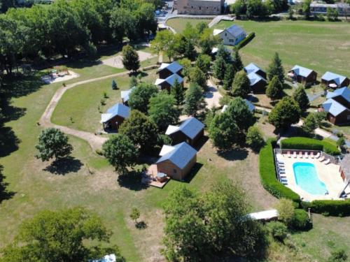 an aerial view of a house with a swimming pool at Chalets de la Colagne in Chirac