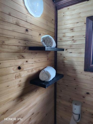 two towels on shelves on a wooden wall at Oluhle Resort in Hammanskraal