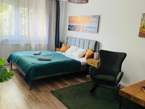 a bedroom with a bed and a chair at Buda Side Comfort in Budapest