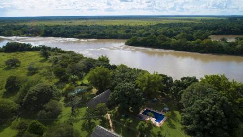 an aerial view of a river with a house next to it at Hato San Pablo in Guayabal
