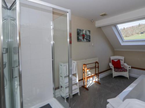a bathroom with a shower and a window at Penlone Cottage in Rhayader