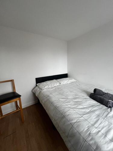 a bedroom with a large bed and a chair at Overton 1 in London